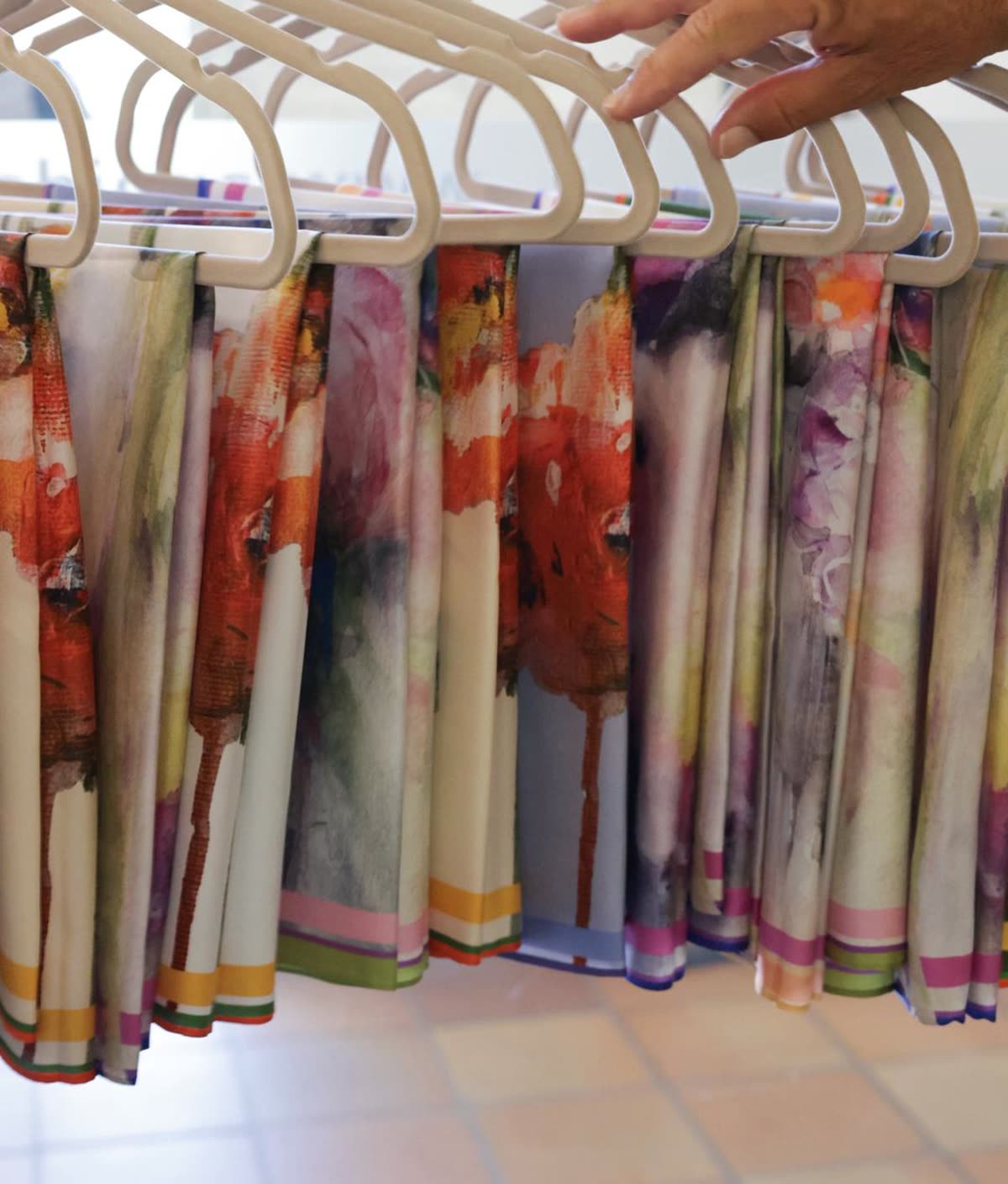 Hand-painted silk scarves hanging in the atelier